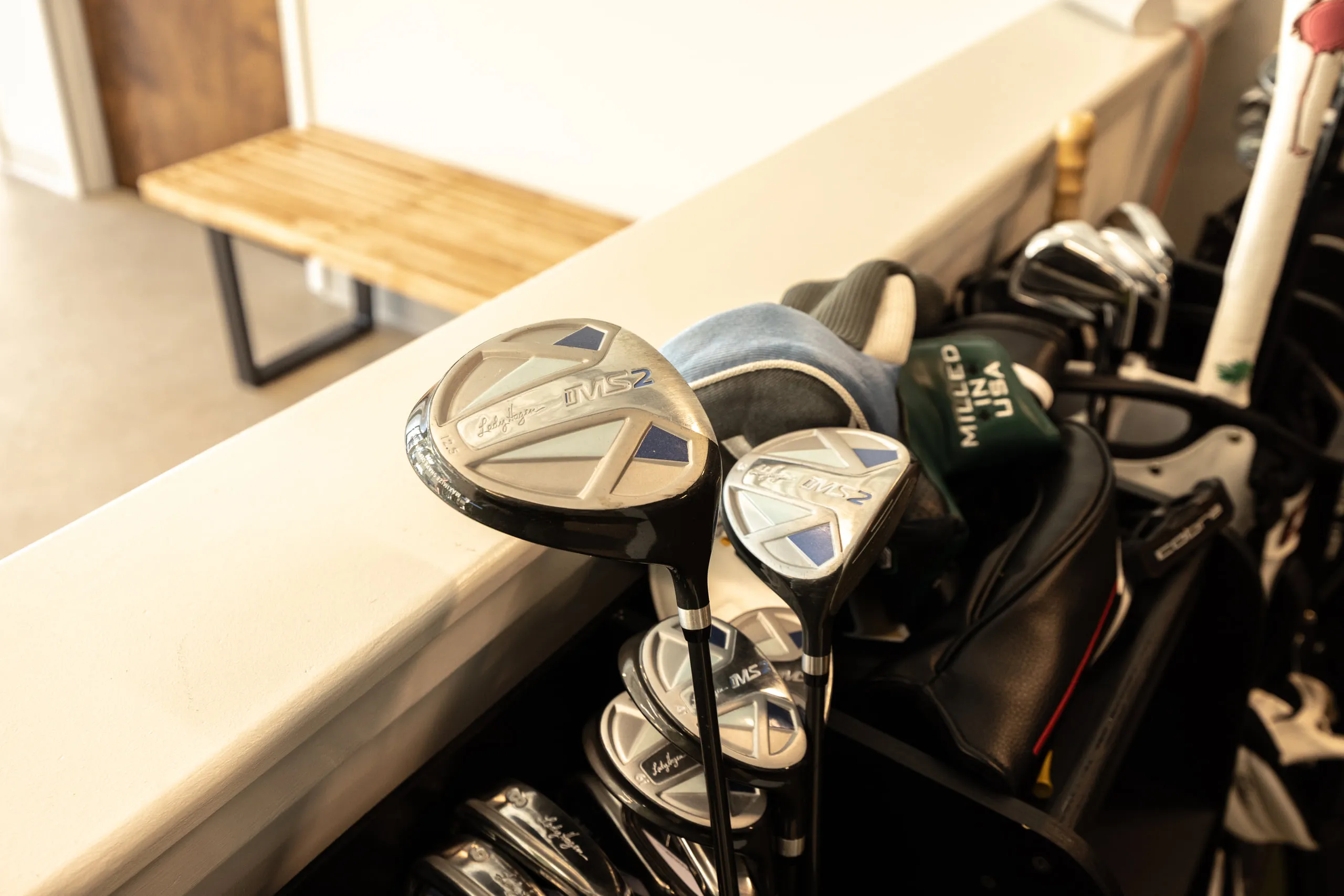 Golf clubs racked beside the bay counter at All Square.
