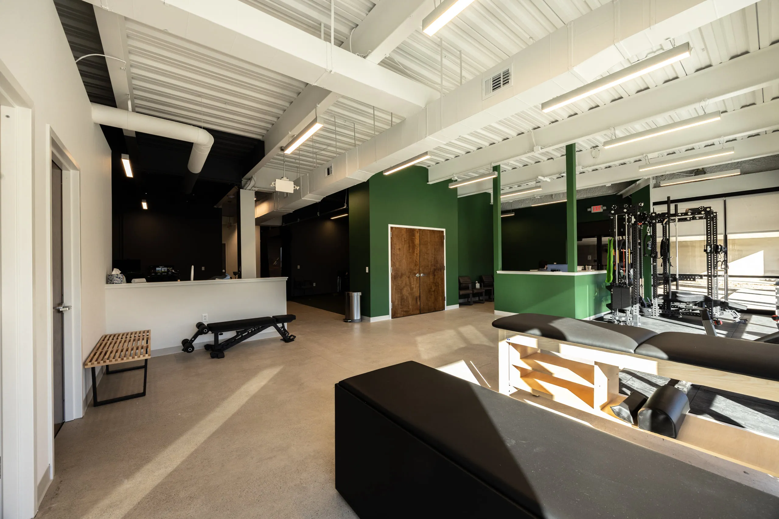 The main floor at All Square Performance Chiropractic, looking across the treatment and training areas.
