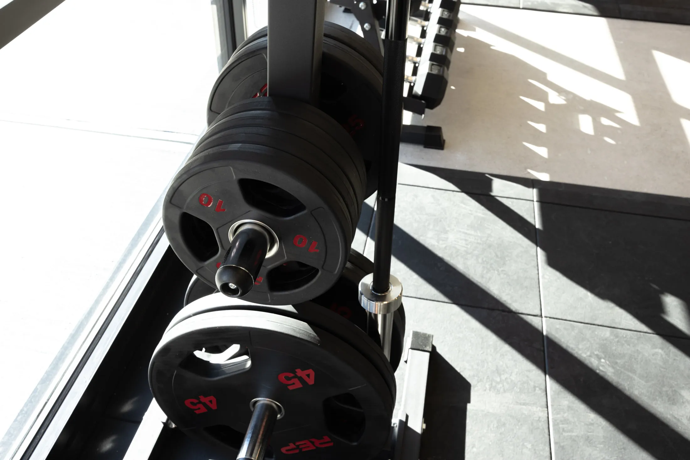 Weight plates racked in daylight.