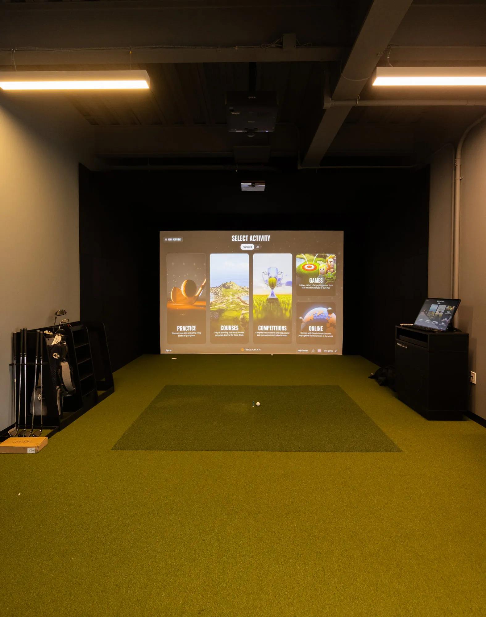 A simulator bay at All Square, lit by the projection screen.