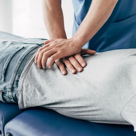 A chiropractor performing a back adjustment.